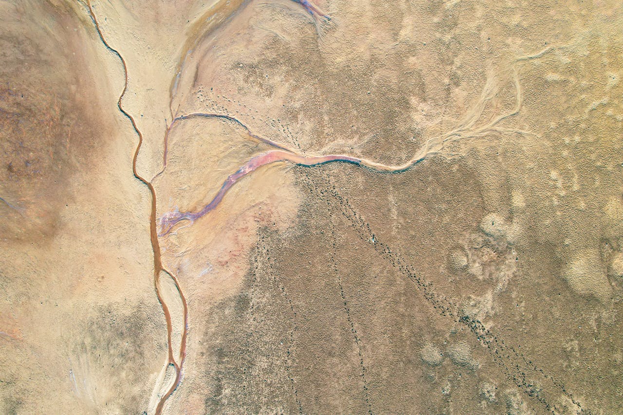 Breathtaking aerial photograph showcasing an arid desert with winding river captured from above.